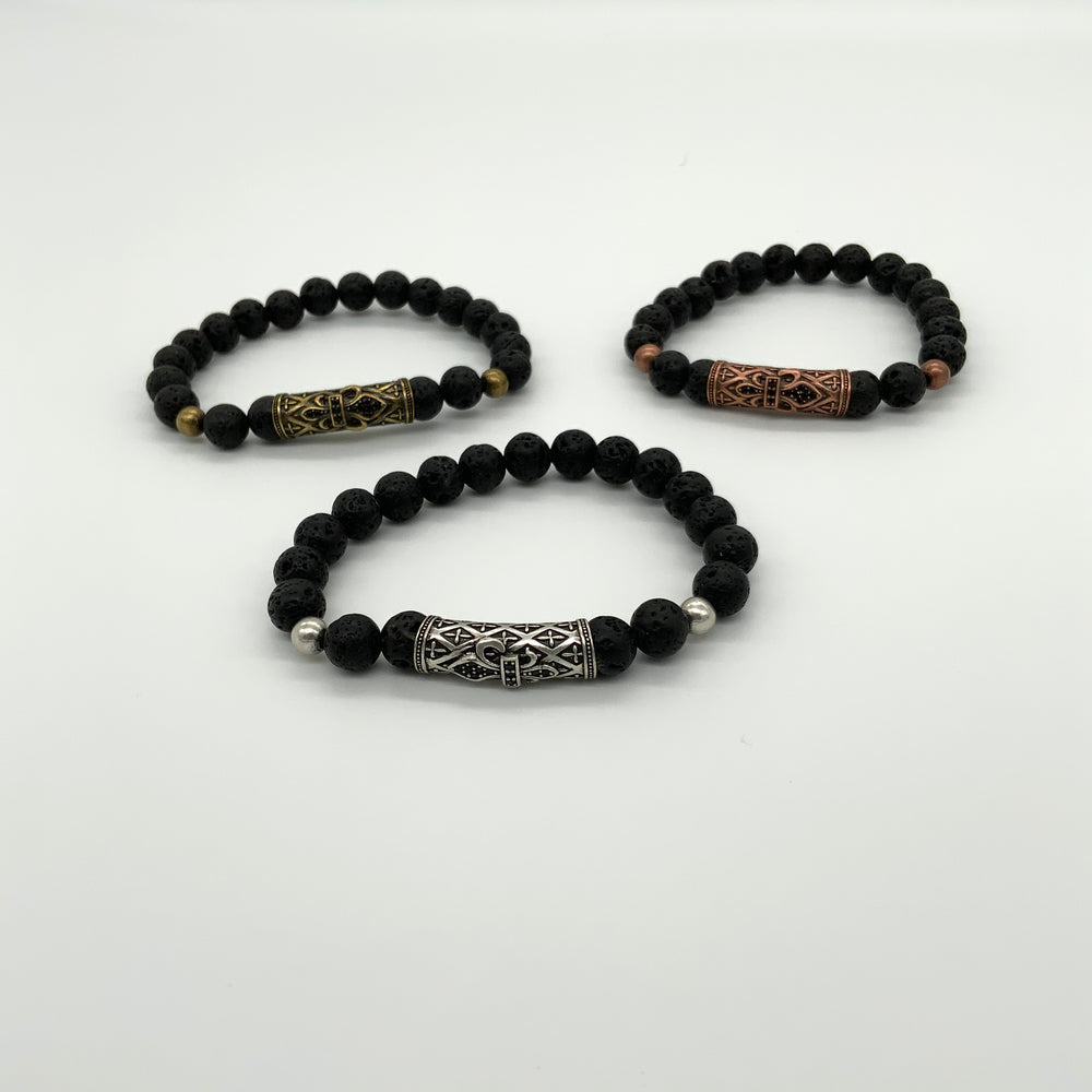 
                  
                    3  black lava rock bracelets with a large accent bead in center displayed in a triangle. Silver center front, gold back left, and bronze back right
                  
                